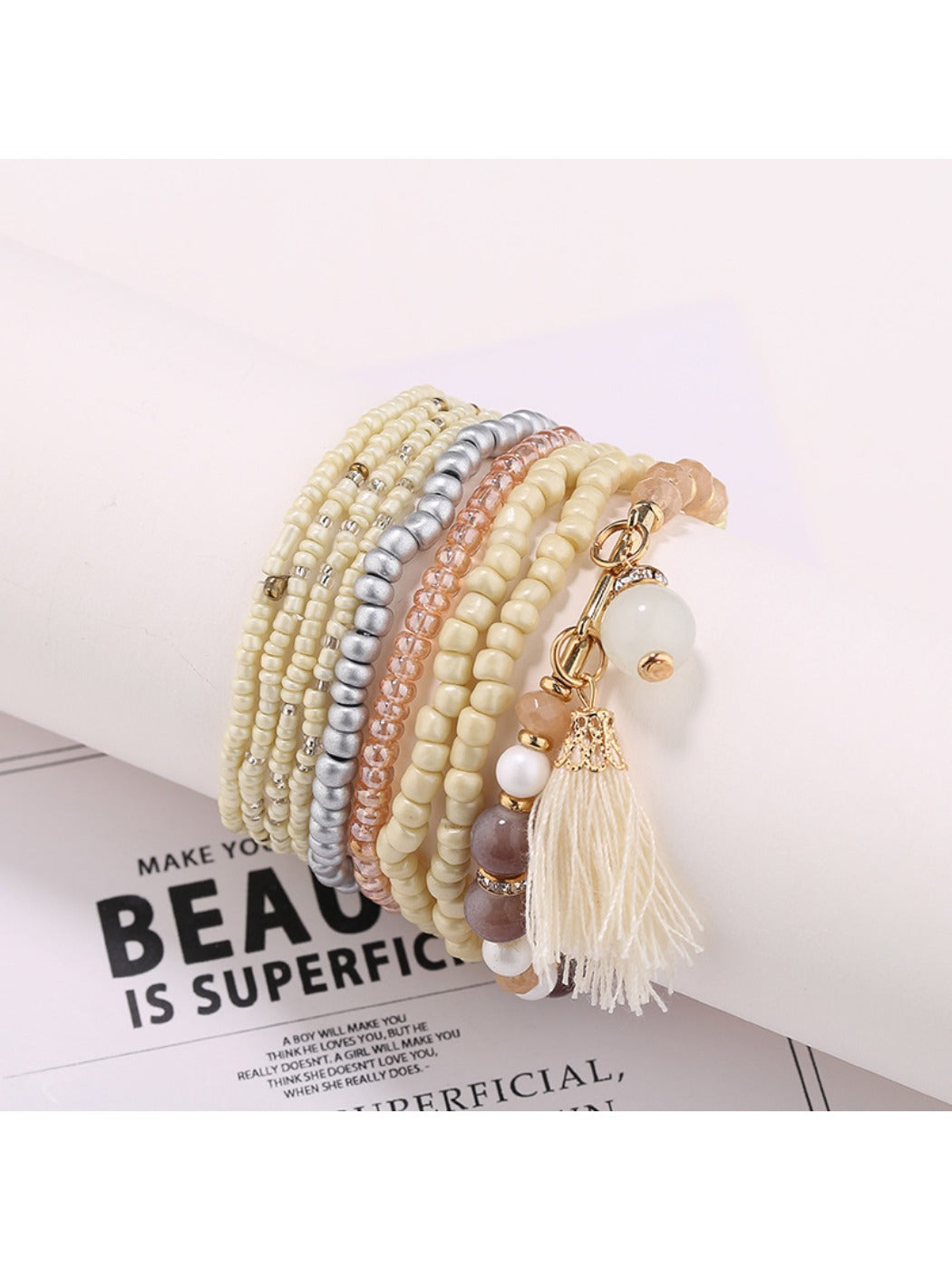 Lovra bracelet draped over a white surface showing bead colors and shine