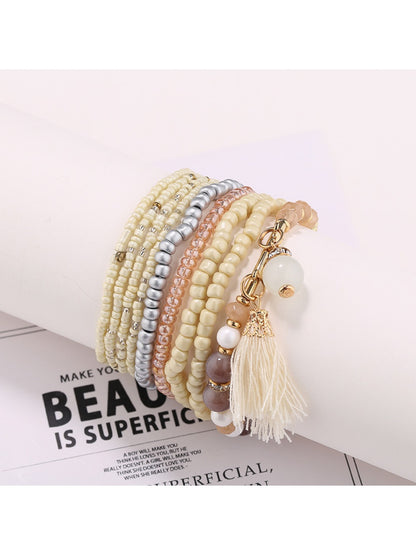 Lovra bracelet draped over a white surface showing bead colors and shine