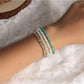 Lovra Bohemian multi strand bracelet with colorful beads and gold accents on a white background