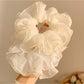 Close-up of double layered tulle fabric scrunchie showing texture and volume