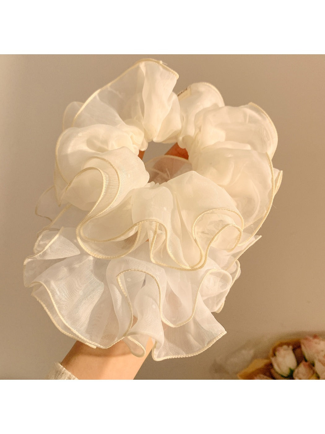 Close-up of double layered tulle fabric scrunchie showing texture and volume