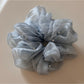Side view of Gifty scrunchie showing gathered fabric and stitching