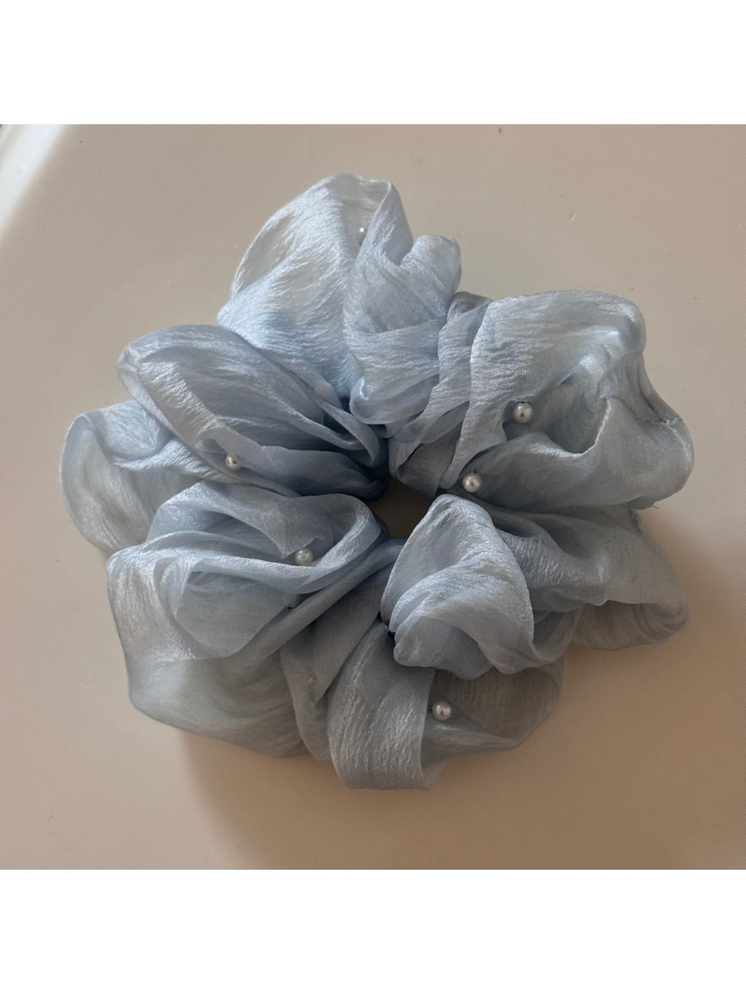 Side view of Gifty scrunchie showing gathered fabric and stitching