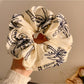 Vintage style scrunchie with coconut tree print on beige fabric