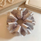 Silver satin double layer ruffle scrunchie on white background