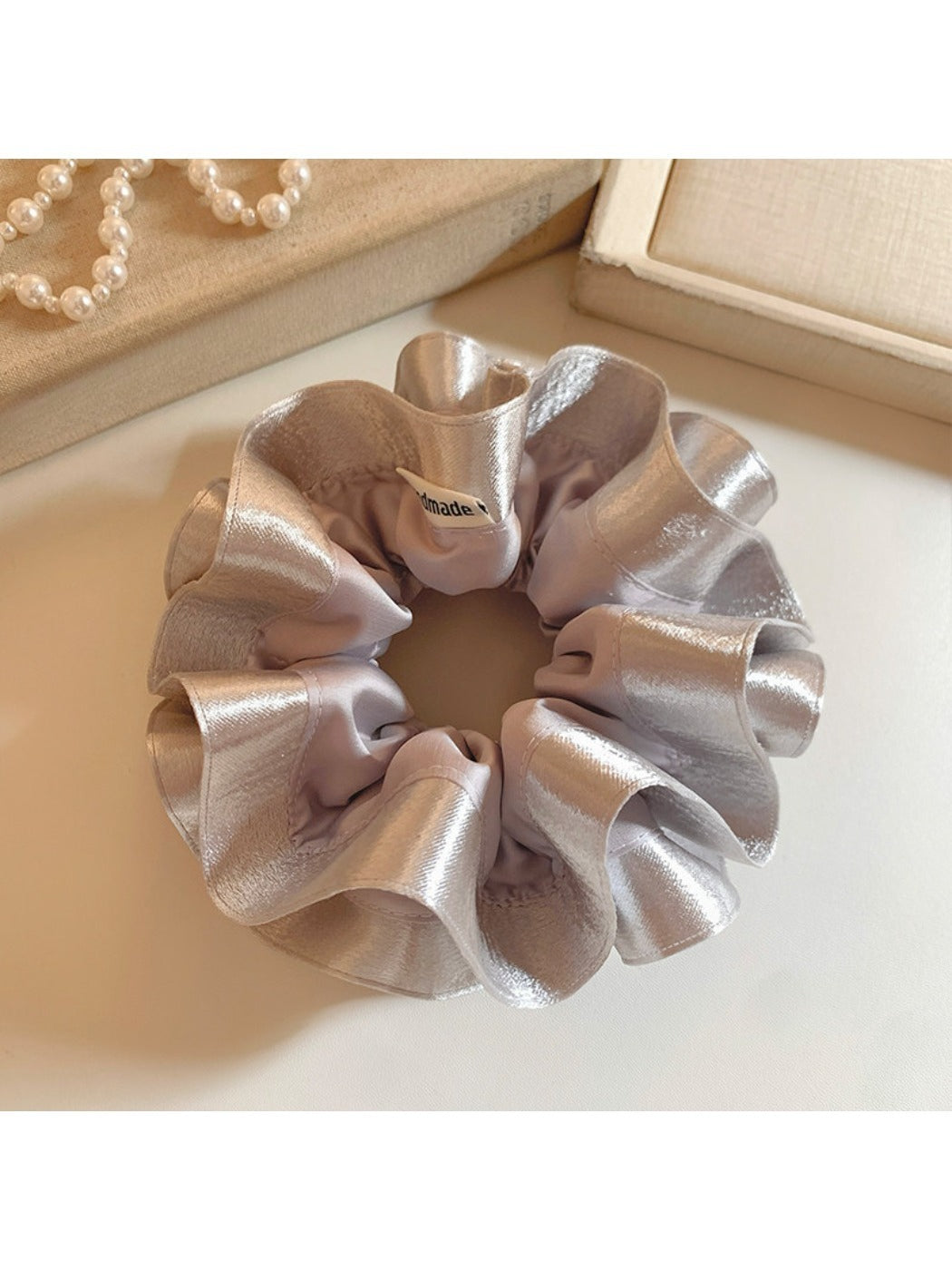 Silver satin double layer ruffle scrunchie on white background