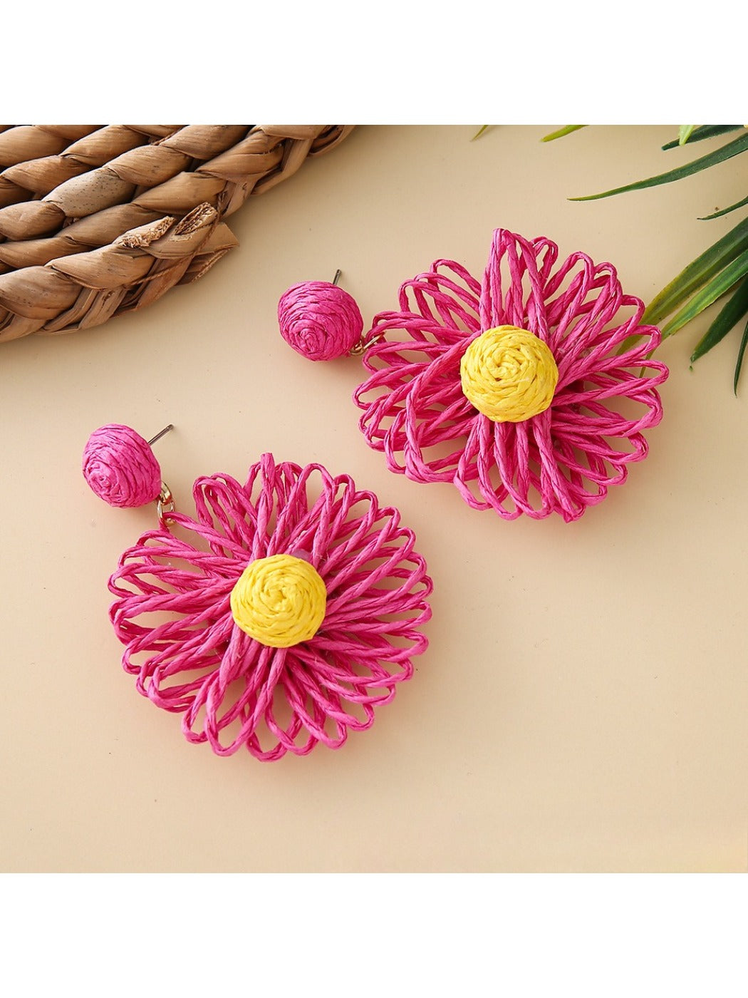 Close-up of earring back showing gold-tone stud and raffia flower front