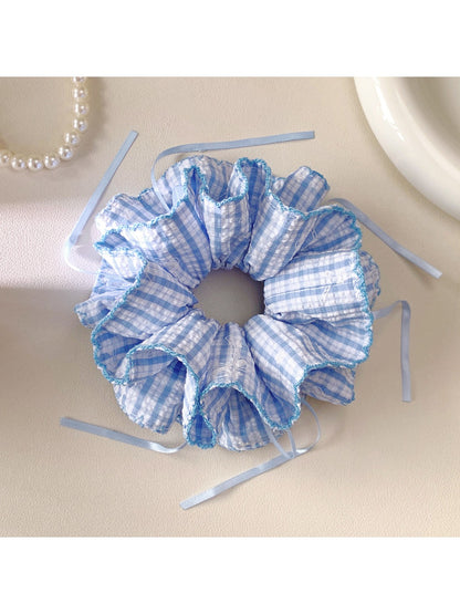 Close-up of blue plaid fabric and elastic band of the double layer scrunchie