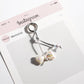 Keypus keychain held in a hand showing its compact size