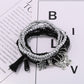 Lovra beaded bracelet with butterfly pendant shown alongside matching jewelry