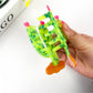Close-up of green cactus hair clip showing spines and smooth surface
