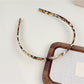 Gifty headband in solid color with glossy finish shown from front angle