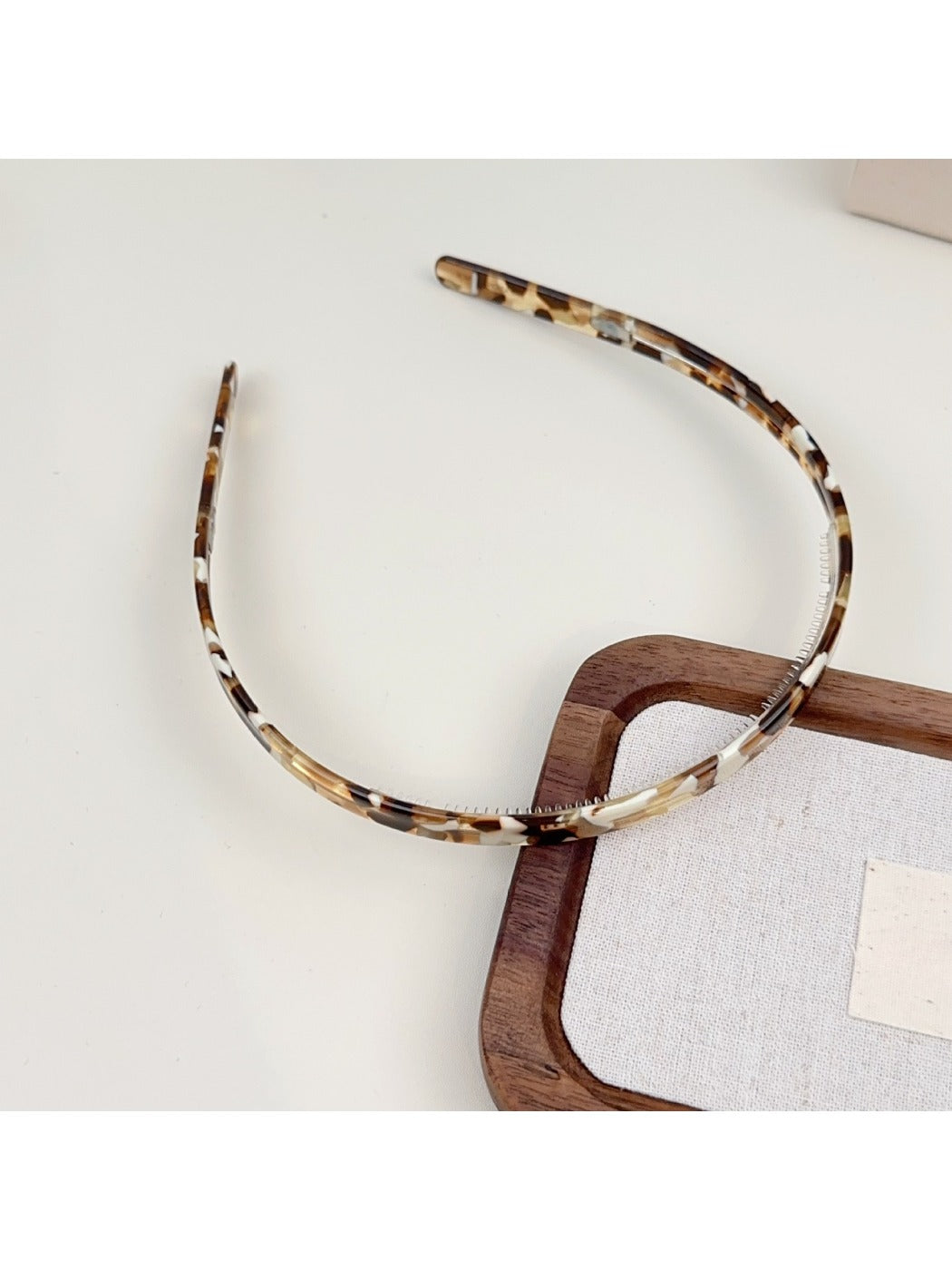 Gifty headband in solid color with glossy finish shown from front angle