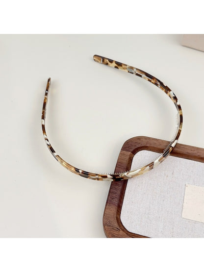 Gifty headband in solid color with glossy finish shown from front angle