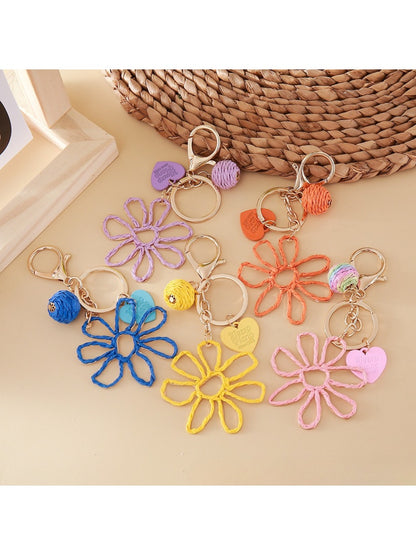 Close-up of raffia hollow flower shaped keychain with natural woven texture