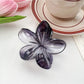 Beau classic flower claw clip with bright pink, yellow, and green colors on white background