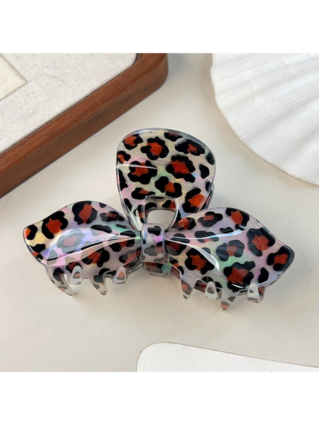 Beau leopard print bow claw clip displayed with matching outfit