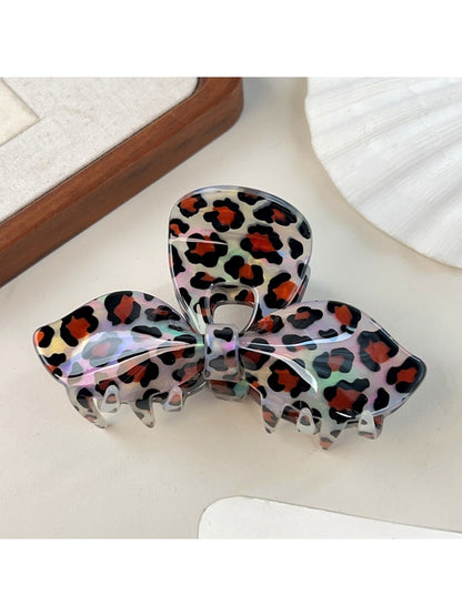 Beau leopard print bow claw clip displayed with matching outfit