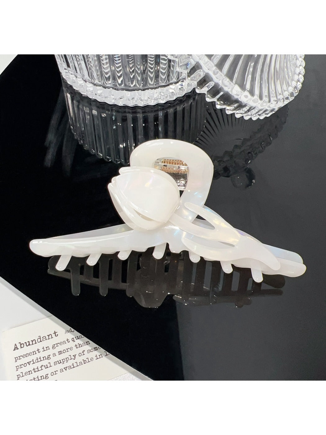 Beau floral hair claw clip held in hand showing size and grip