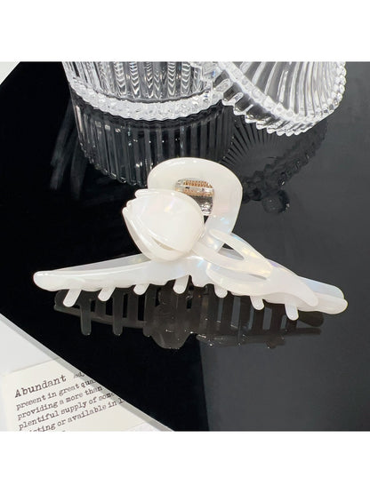 Beau floral hair claw clip held in hand showing size and grip