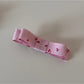 Beau pink floral hair clip photographed with soft natural lighting