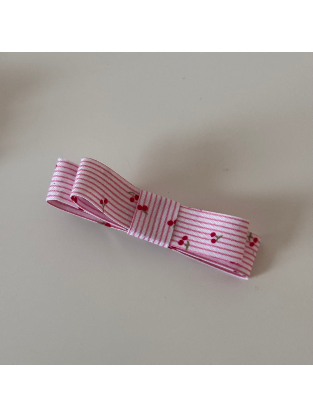 Beau pink floral hair clip photographed with soft natural lighting