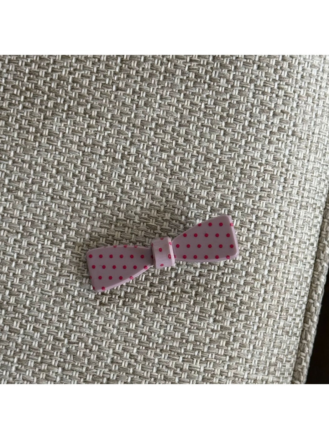 Beau pink polka dot claw clip held in hand showing size and grip