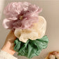 Gifty scrunchie displayed on a white background showing its texture and color