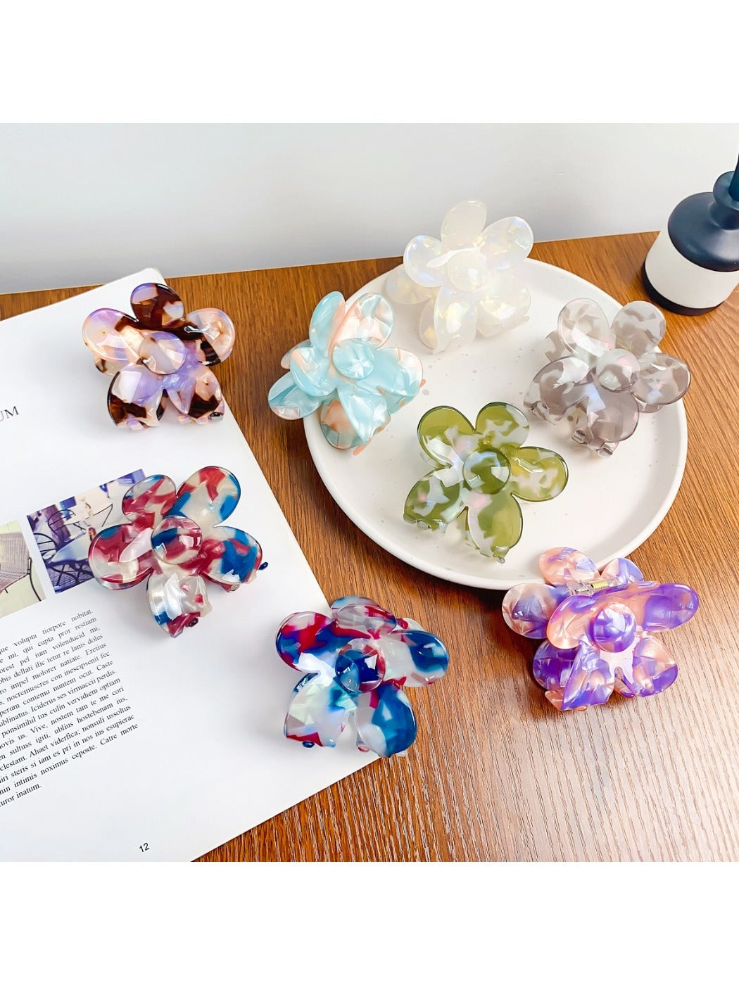 Colorful flower-shaped hair claw clip with vibrant petals on white background