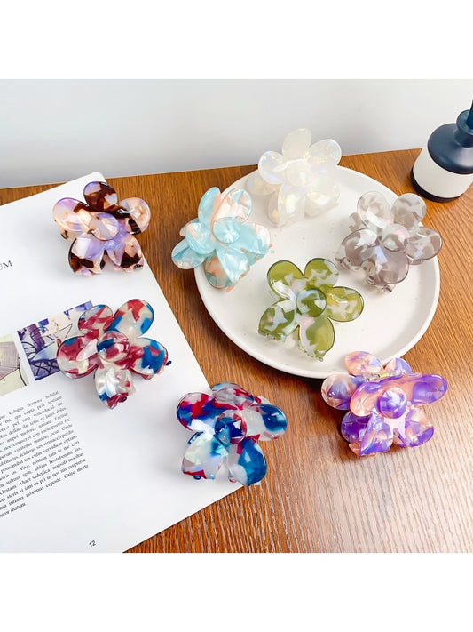 Colorful flower-shaped hair claw clip with vibrant petals on white background