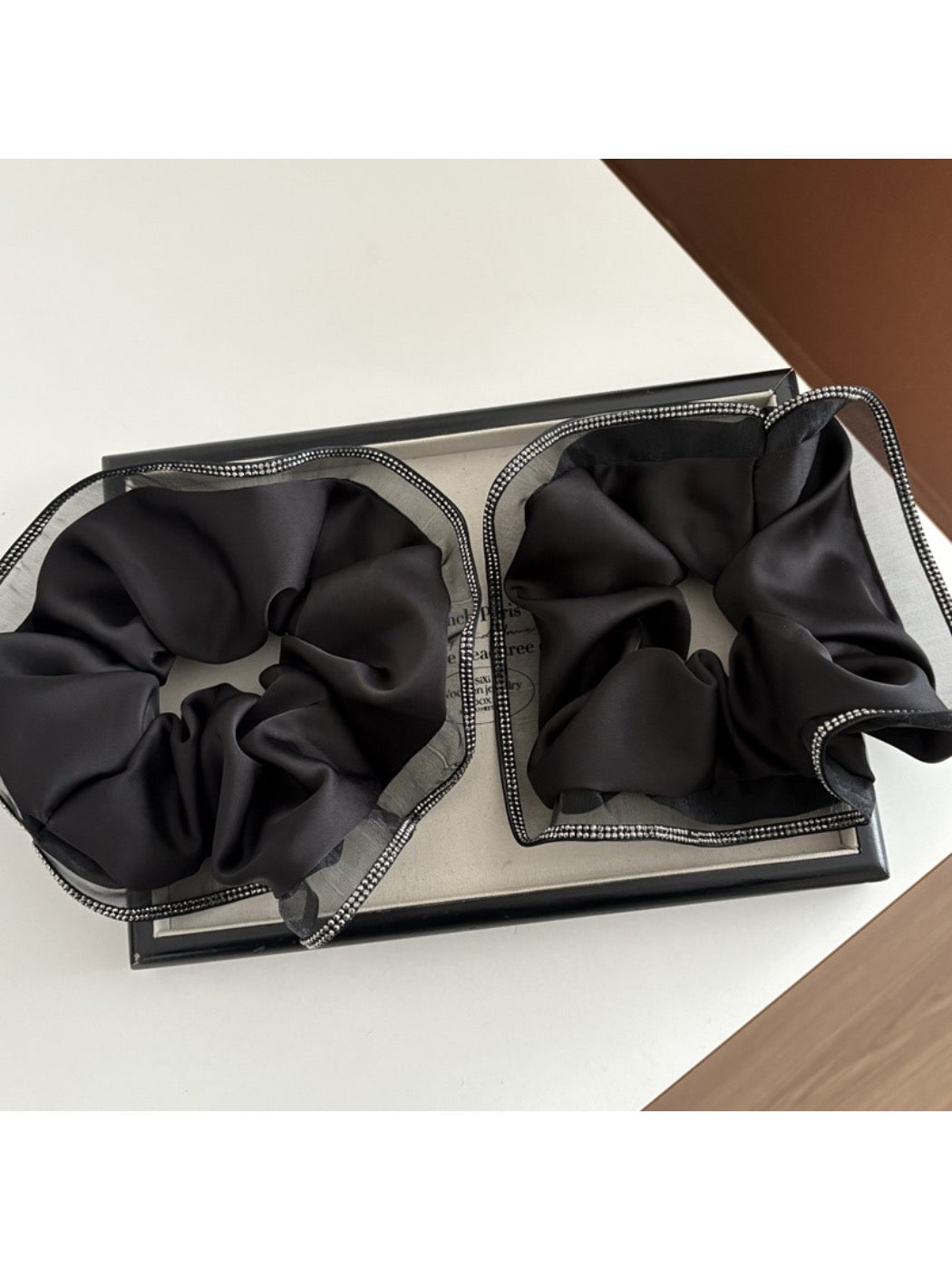 Close-up of Gifty minimalist scrunchie showing smooth fabric texture and gentle folds