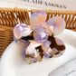 Flower hair claw clip with colorful petals arranged in a circular pattern