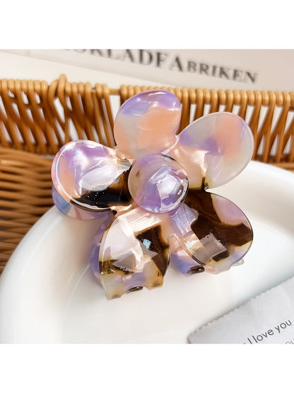 Flower hair claw clip with colorful petals arranged in a circular pattern