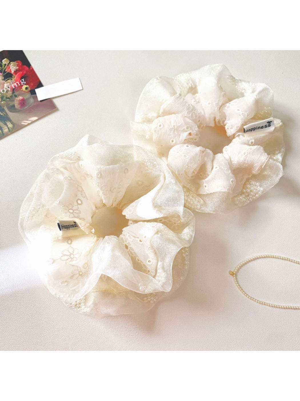 White tulle ruffle scrunchie displayed on a plain white background