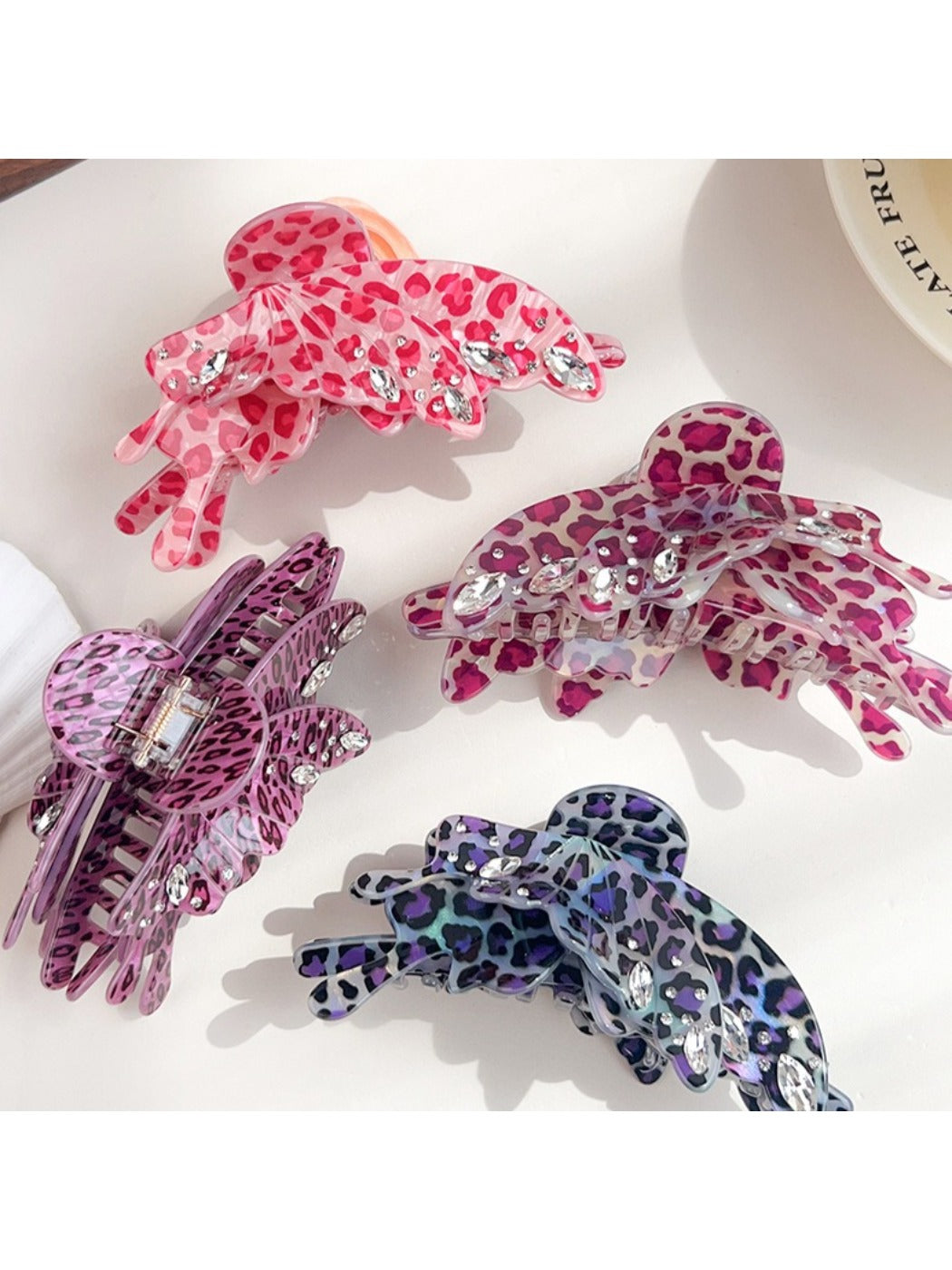 Side view of Beau butterfly claw clip with leopard print design