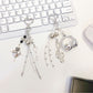 Love Headphone Shaped Keychain attached to a set of keys on a wooden surface