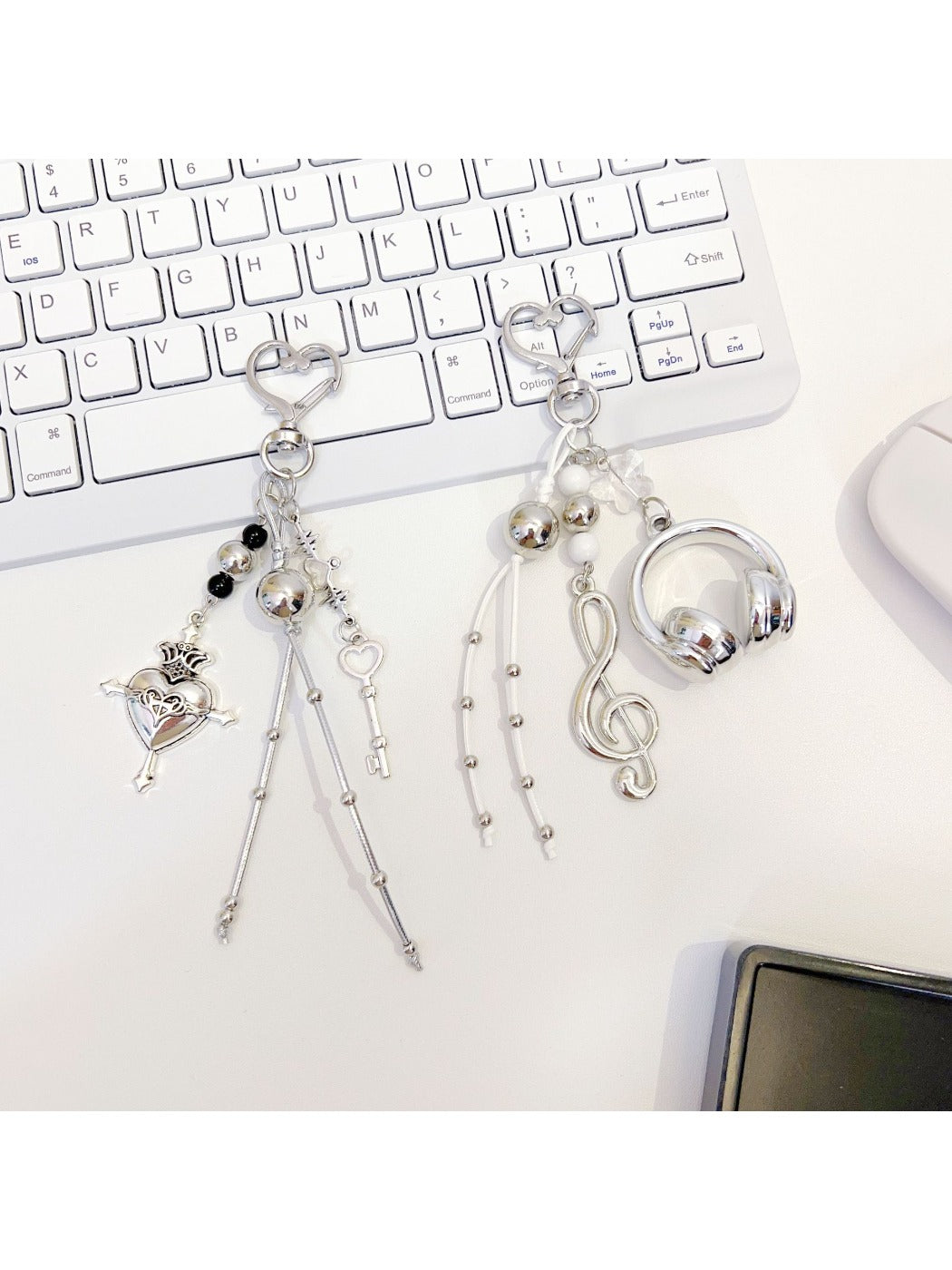 Love Headphone Shaped Keychain attached to a set of keys on a wooden surface