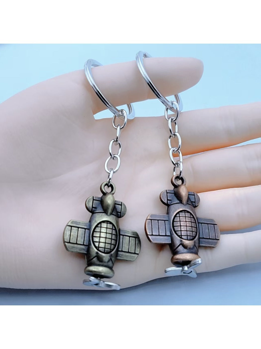 Close-up of a lifelike airplane shaped keychain with detailed wings and tail