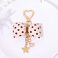 Keypus bow keychain displayed on a white background with metal keyring visible