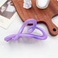Beau heart shaped bow claw clip in ombre pink and purple gradient with soft shadows