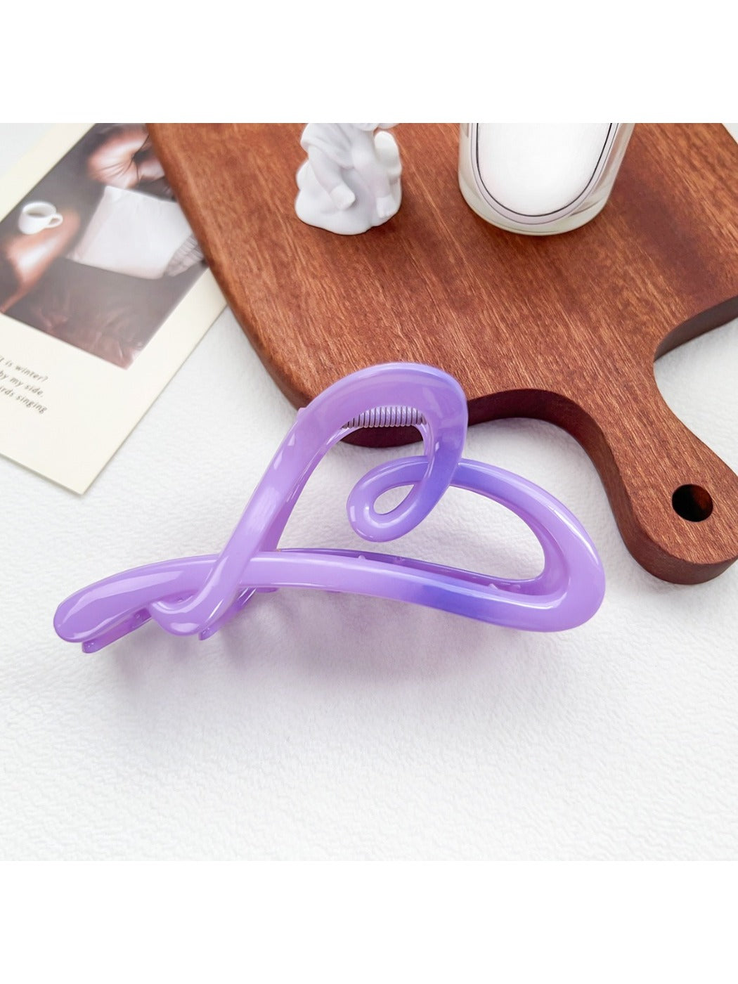 Beau heart shaped bow claw clip in ombre pink and purple gradient with soft shadows