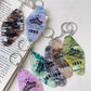 Close-up of the diamond-shaped pendant showing detailed colorful facets and metal keyring