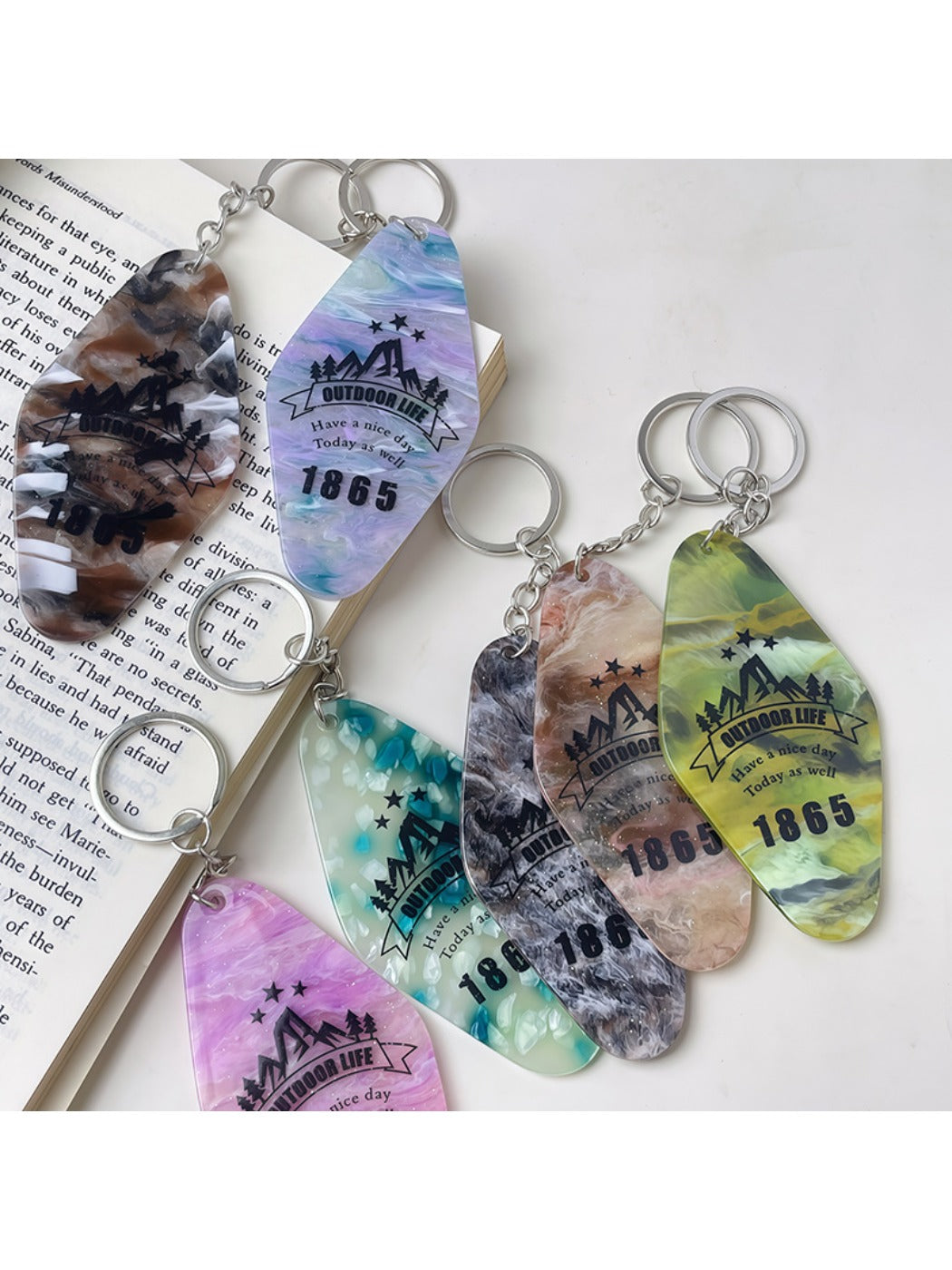 Close-up of the diamond-shaped pendant showing detailed colorful facets and metal keyring