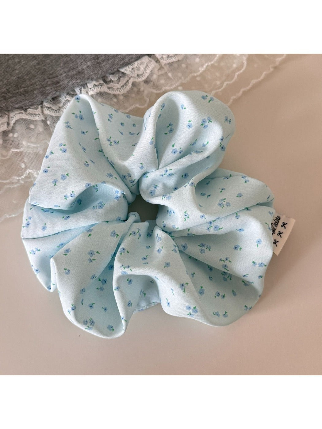 Model wearing Gifty tiny floral print scrunchie in her hair outdoors
