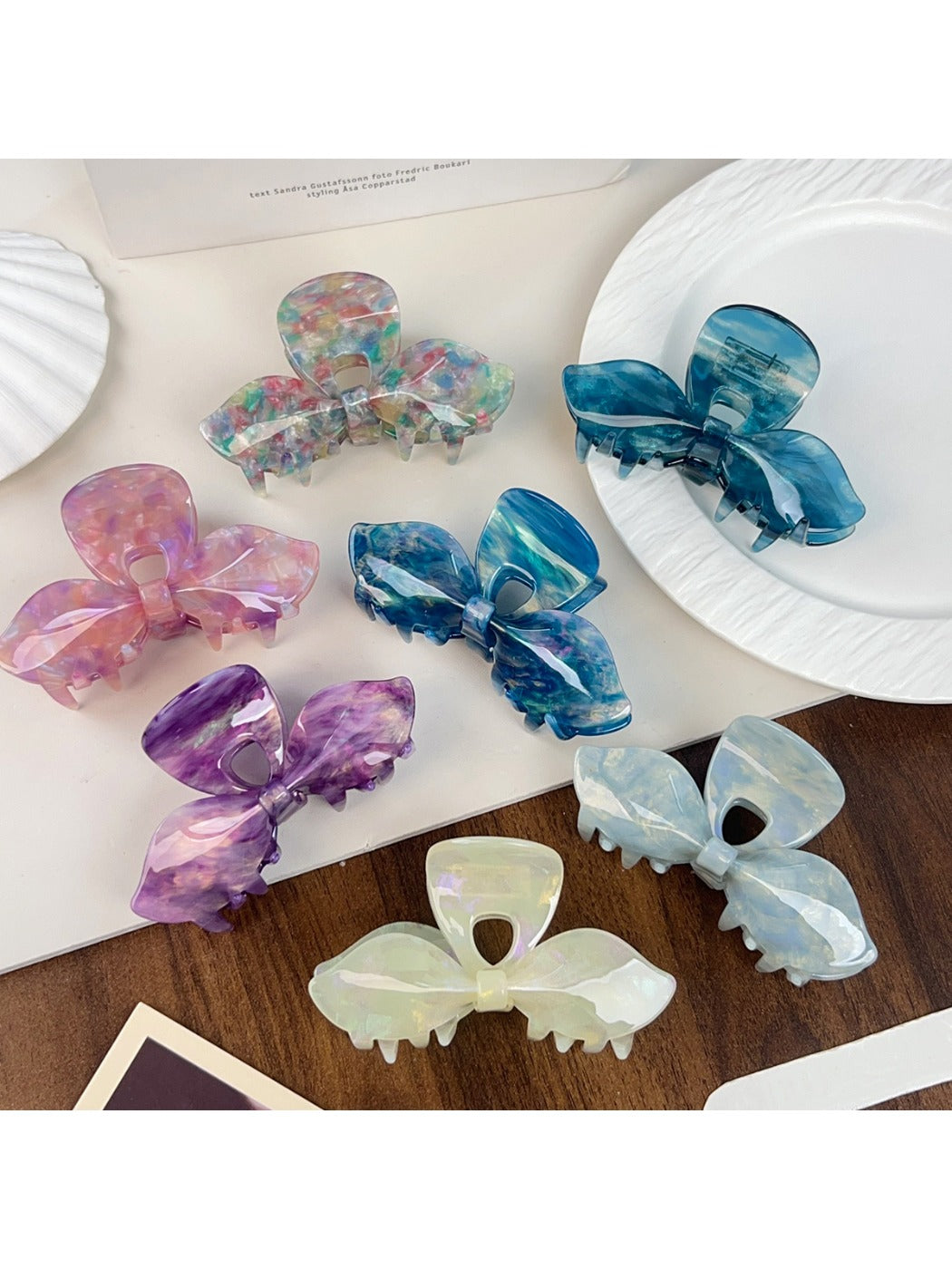 Beau iridescent bow-shaped hair claw clip on white background