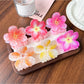 Close-up of Beau lifelike acetate floral claw clip with pink and white flower design