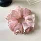 Close-up of vintage pink ruffled scrunchie made of soft fabric