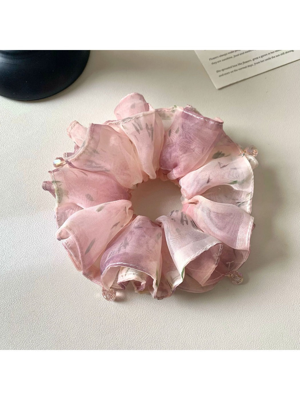 Close-up of vintage pink ruffled scrunchie made of soft fabric