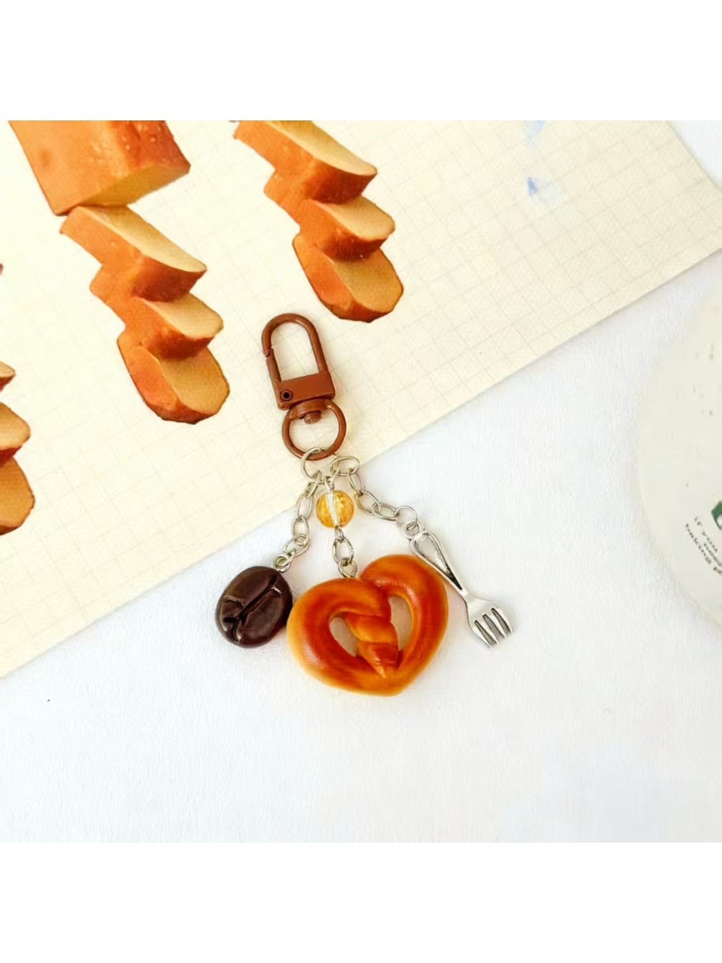 Mini baguette keychain showing detailed stitching on light brown leather