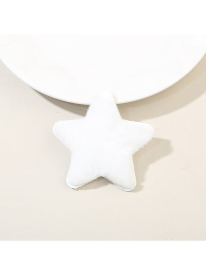 Beau star hair clip held between fingers showing size and plush material